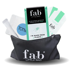 Black 'fab'Little Bag with tampon applicators and packaging on a white background