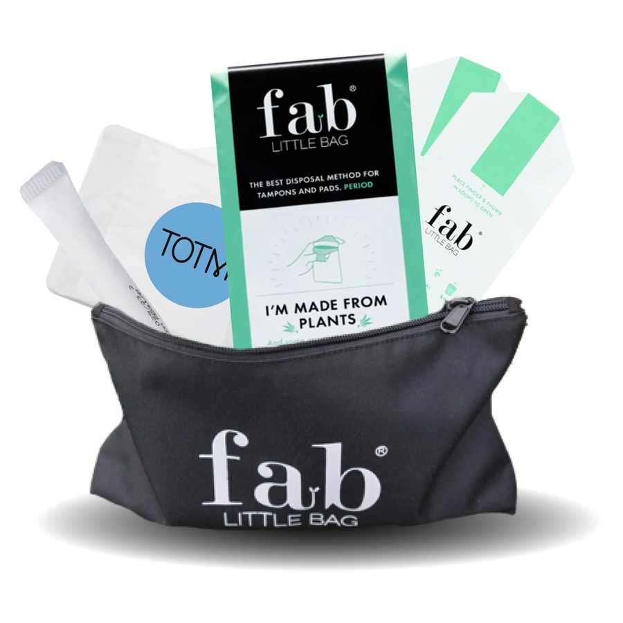 Black 'fab'Little Bag with tampon applicators and packaging on a white background